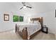 Bright bedroom features a ceiling fan and a window with a view of the trees at 2435 Roxburgh Dr, Roswell, GA 30076
