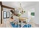 Bright dining room featuring hardwood floors, stylish chandelier, and staircase access at 2435 Roxburgh Dr, Roswell, GA 30076