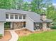 View of the exterior highlighting stonework, windows, and landscaping at 2435 Roxburgh Dr, Roswell, GA 30076