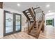 Inviting foyer with wood staircase, stylish flooring, and double glass front doors at 2435 Roxburgh Dr, Roswell, GA 30076