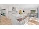 Open kitchen with bar stool seating that flows into the living room at 2435 Roxburgh Dr, Roswell, GA 30076