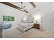Bright main bedroom with vaulted ceilings, exposed wood beams, and neutral decor at 2435 Roxburgh Dr, Roswell, GA 30076