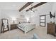 Bright main bedroom with vaulted ceilings, exposed wood beams, and neutral decor at 2435 Roxburgh Dr, Roswell, GA 30076