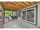 Covered patio area with outdoor seating and access to the backyard at 2435 Roxburgh Dr, Roswell, GA 30076