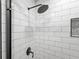 Modern shower featuring white subway tile, sleek fixtures, and a glass door at 2435 Roxburgh Dr, Roswell, GA 30076