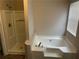 Bathroom featuring a bathtub, a separate shower, and a window at 4963 Windsor Downs Ln, Decatur, GA 30035