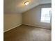 Cozy bedroom featuring a large window, neutral walls with carpeted flooring at 4963 Windsor Downs Ln, Decatur, GA 30035