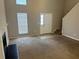 Bright living room with a fireplace, staircase, neutral walls, and lots of natural light at 4963 Windsor Downs Ln, Decatur, GA 30035