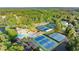 Overview of community featuring swimming pool, tennis courts, parking, green space, and residential buildings surrounded by trees at 979 Pathview Ct, Dacula, GA 30019