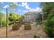 Backyard boasting raised garden beds, a stone fireplace, lush trees, and outdoor accents at 979 Pathview Ct, Dacula, GA 30019