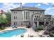 An elevated view of a home and its backyard pool with a stone patio and retaining wall at 979 Pathview Ct, Dacula, GA 30019