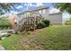 Backyard featuring an in-ground pool, expansive lawn, mature trees, and home's exterior at 979 Pathview Ct, Dacula, GA 30019