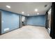 Large carpeted basement living space with natural light and access to a wet bar at 979 Pathview Ct, Dacula, GA 30019