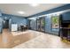 Finished basement with tile floors, dining table, patio access, and an arcade game at 979 Pathview Ct, Dacula, GA 30019
