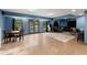 Open finished basement with tile floors, a dining table, patio access, and an arcade game at 979 Pathview Ct, Dacula, GA 30019