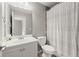 Bathroom featuring a vanity, toilet, and tile shower with a shower curtain at 979 Pathview Ct, Dacula, GA 30019