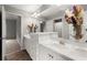 Bathroom featuring a vanity, large mirror, and decorative flowers at 979 Pathview Ct, Dacula, GA 30019