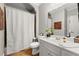 Bright bathroom featuring a white vanity, modern fixtures and a shower with a patterned curtain at 979 Pathview Ct, Dacula, GA 30019