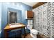 Modern bathroom with a stylish sink, toilet, and a unique patterned shower curtain at 979 Pathview Ct, Dacula, GA 30019
