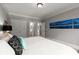 Bedroom showcasing a white bed with decorative pillows, leading to a wardrobe and ensuite at 979 Pathview Ct, Dacula, GA 30019
