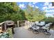 Outdoor deck with grill, dining table, seating, and landscaping at 979 Pathview Ct, Dacula, GA 30019