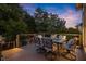 Outdoor dining area on a cozy wood deck with elegant chairs, a table, and a grill at 979 Pathview Ct, Dacula, GA 30019