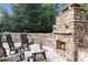 Inviting outdoor fireplace with stone surround and seating area, perfect for entertaining and relaxing at 979 Pathview Ct, Dacula, GA 30019