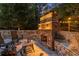 Outdoor stone fireplace with seating and a table, perfect for evening gatherings at 979 Pathview Ct, Dacula, GA 30019