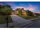 Attractive brick home featuring a lush lawn, manicured landscaping, and a long driveway at 979 Pathview Ct, Dacula, GA 30019