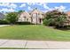 Stunning brick home featuring lush landscaping and a sprawling green lawn at 979 Pathview Ct, Dacula, GA 30019