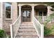Inviting front entrance with classic brick steps and white railing at 979 Pathview Ct, Dacula, GA 30019