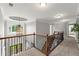 Hallway with carpeted floors and wooden railings overlooking the home's entrance at 979 Pathview Ct, Dacula, GA 30019
