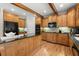 Kitchen features wood cabinets, granite countertops, hardwood floors, and stainless appliances at 979 Pathview Ct, Dacula, GA 30019