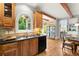 Kitchen with wood cabinets, granite countertops, black appliances and hardwood floors at 979 Pathview Ct, Dacula, GA 30019