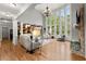 Spacious living room features hardwood floors, stone fireplace, and tall windows at 979 Pathview Ct, Dacula, GA 30019