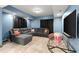 Cozy living room with blue walls, plush gray sectional sofa, and modern TV, perfect for relaxing evenings at 979 Pathview Ct, Dacula, GA 30019