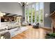 Bright living room with soaring windows, hardwood floors, and a stone fireplace at 979 Pathview Ct, Dacula, GA 30019
