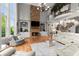 Bright living room with high ceilings, stone fireplace, built-in shelving, and hardwood floors at 979 Pathview Ct, Dacula, GA 30019