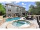 Large inground pool with an adjacent spa and stone patio, providing an ideal spot for outdoor entertaining at 979 Pathview Ct, Dacula, GA 30019