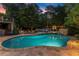 Backyard pool and spa area with stone accents, lounge chairs, and inviting ambiance at 979 Pathview Ct, Dacula, GA 30019
