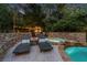 Resort-like backyard pool and spa area with stone features, a fireplace, and lounge seating at 979 Pathview Ct, Dacula, GA 30019