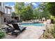 Backyard in-ground pool with lounge chairs and stone retaining walls at 979 Pathview Ct, Dacula, GA 30019