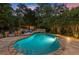 Inviting backyard pool and spa with stone surround, lounge chairs, and privacy landscaping at 979 Pathview Ct, Dacula, GA 30019