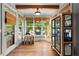 Sunroom with hardwood floors, pet house, and lots of windows at 979 Pathview Ct, Dacula, GA 30019