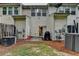 Backyard of townhouse with patio area and air conditioning units at 1203 Penhurst Way, Lawrenceville, GA 30043