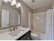 Bathroom with single vanity, mirror, lighting, and bath/shower combination at 1203 Penhurst Way, Lawrenceville, GA 30043
