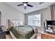 Bedroom with bed, window, ceiling fan, and desk with computer at 1203 Penhurst Way, Lawrenceville, GA 30043
