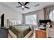 Bedroom with bed, window, ceiling fan, and desk with computer at 1203 Penhurst Way, Lawrenceville, GA 30043