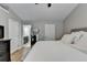 This bedroom features a comfortable bed with white bedding, a ceiling fan, and a full-length mirror at 1203 Penhurst Way, Lawrenceville, GA 30043