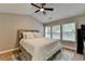 Comfortable bedroom with a ceiling fan, plush rug, and sunny windows at 1203 Penhurst Way, Lawrenceville, GA 30043